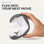 Barevon White cord-lace shoe held in a gentle U-shaped bend to illustrate flexibility. Flex into your next move.