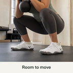 White Barevon cord-lace shoes during a goblet squat mobility hold; room to move.