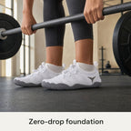 White Barevon cord-lace shoes during a grounded barbell deadlift; zero-drop foundation.