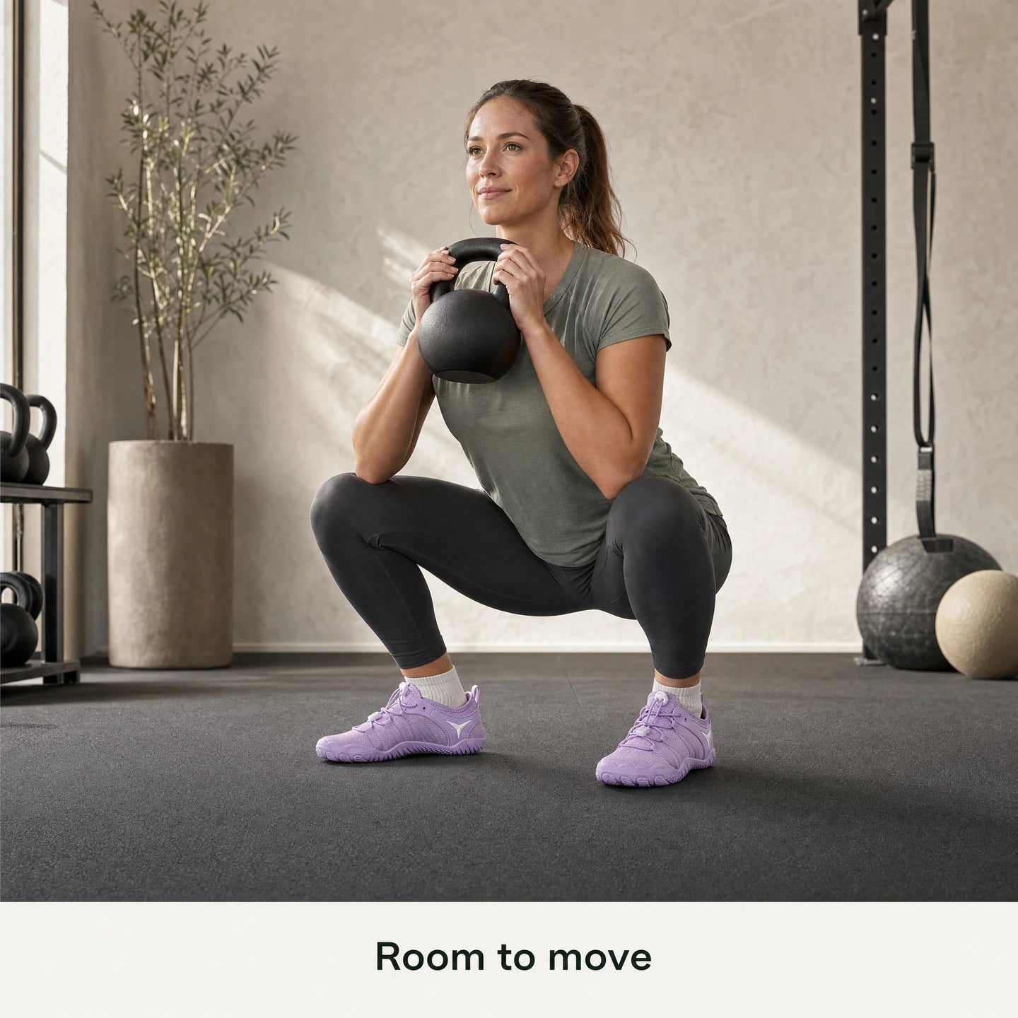 Adult woman performing a goblet squat in lavender Barevon Original shoes.