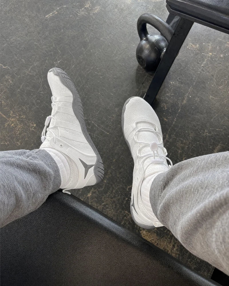 White Barevon shoes beside a kettlebell between sets.