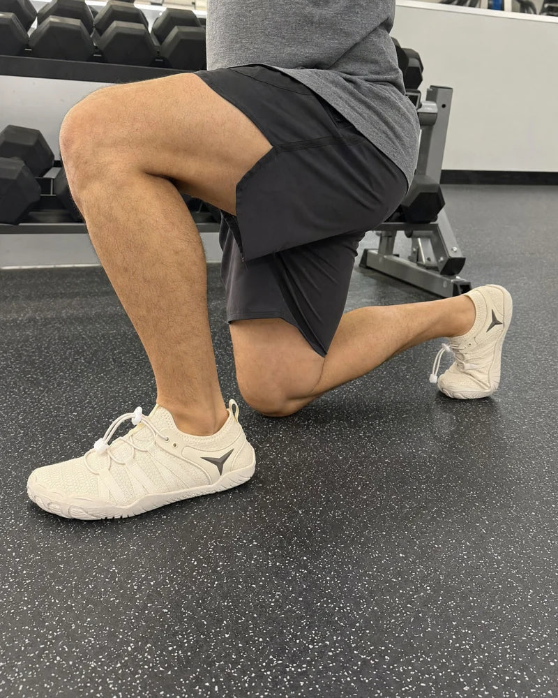 Beige Barevon shoes during a gym split squat.