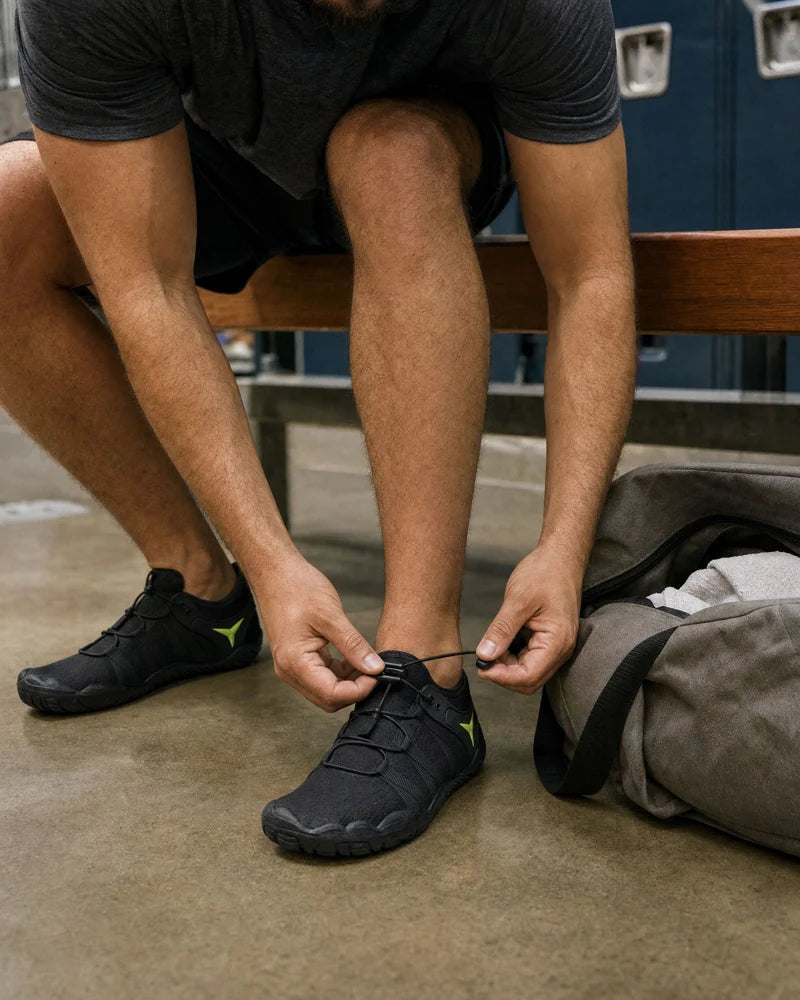 Adjusting the cord laces on black Barevon shoes.