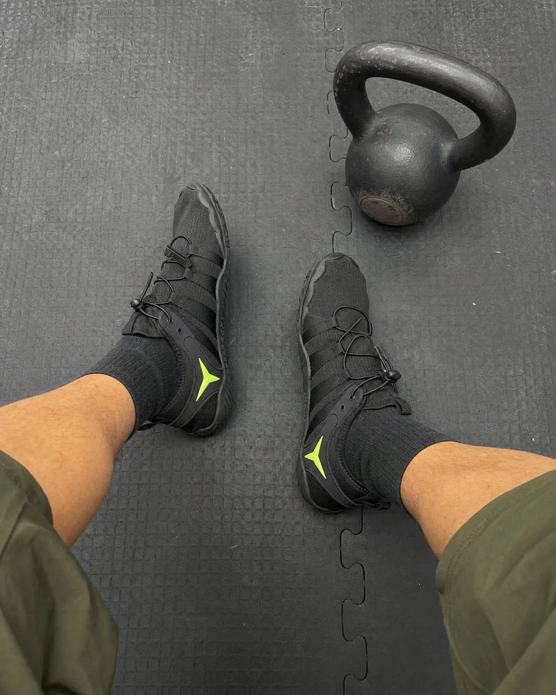 Black Barevon shoes beside a kettlebell.